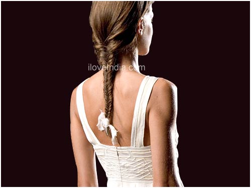Braid one side of your hair by parting it in the middle and securing it with 